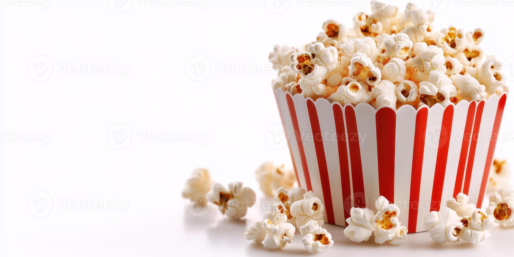 Popcorn in striped cup, scattered kernels on white surface, perfect for movie nights and gatherings, evoking a sense of nostalgia and fun photo