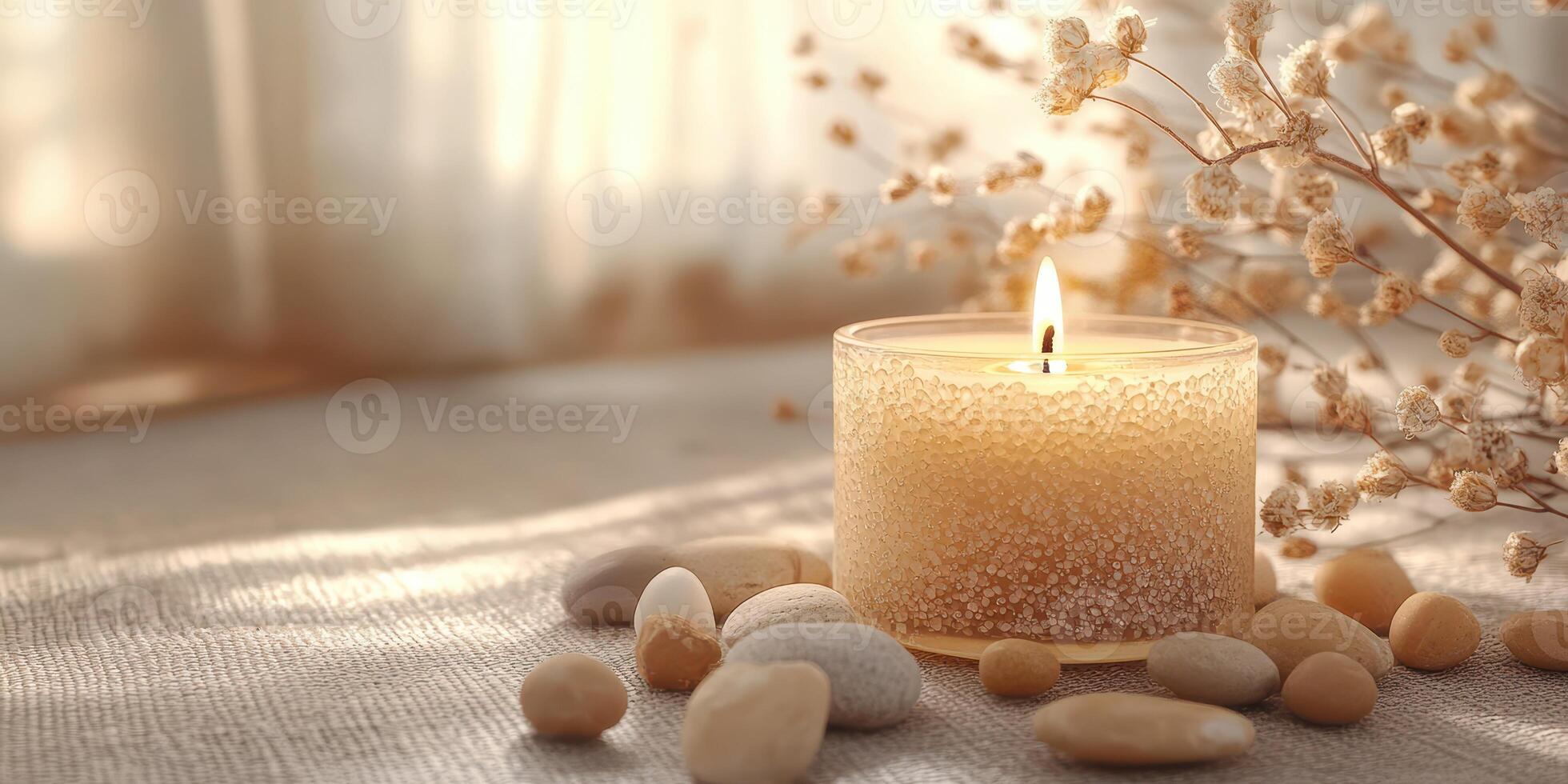Relaxing evening with a lit candle and decorative stones in a peaceful setting photo
