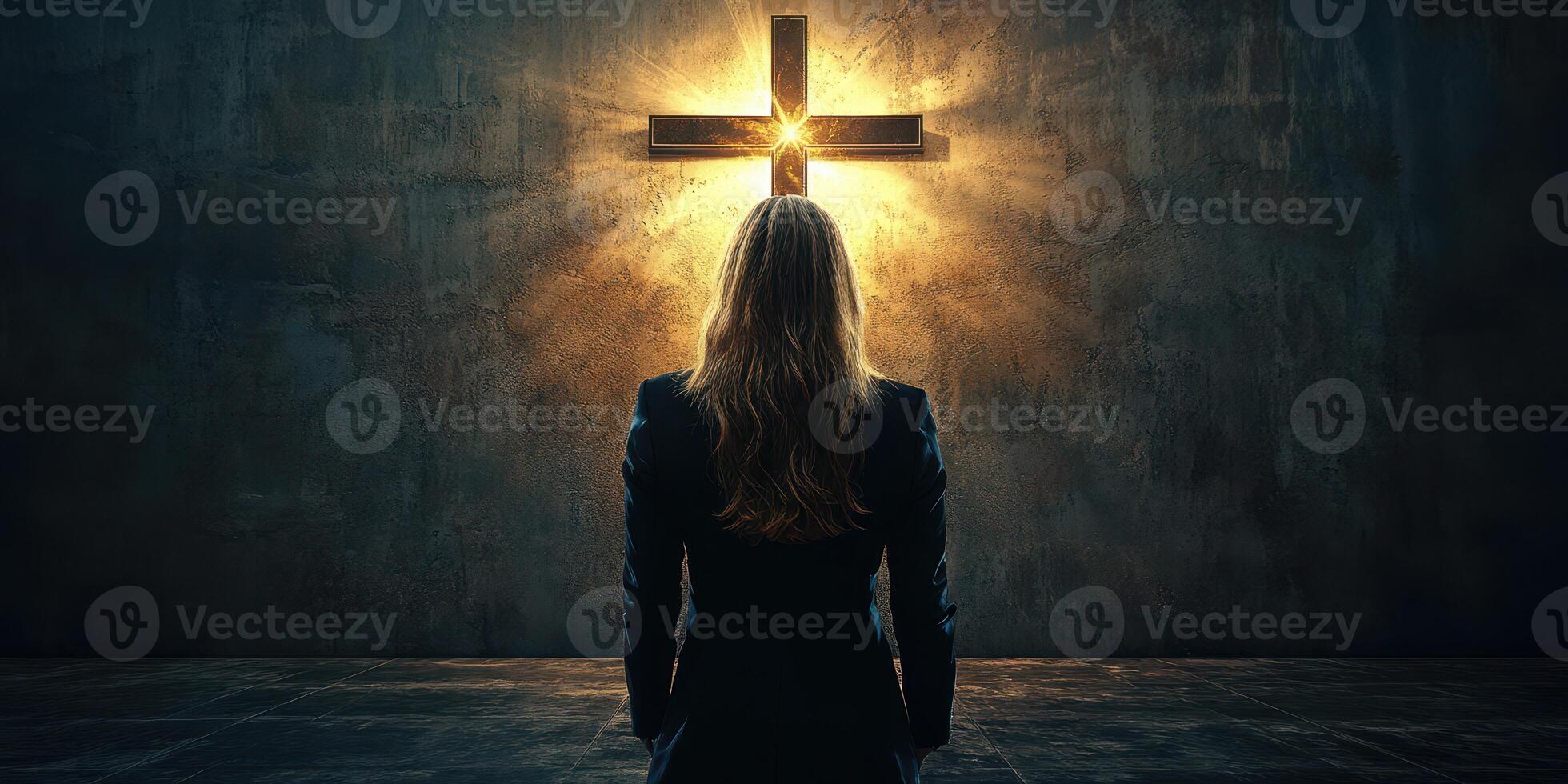 Woman standing in front of illuminated cross in dimly lit room during evening contemplation photo