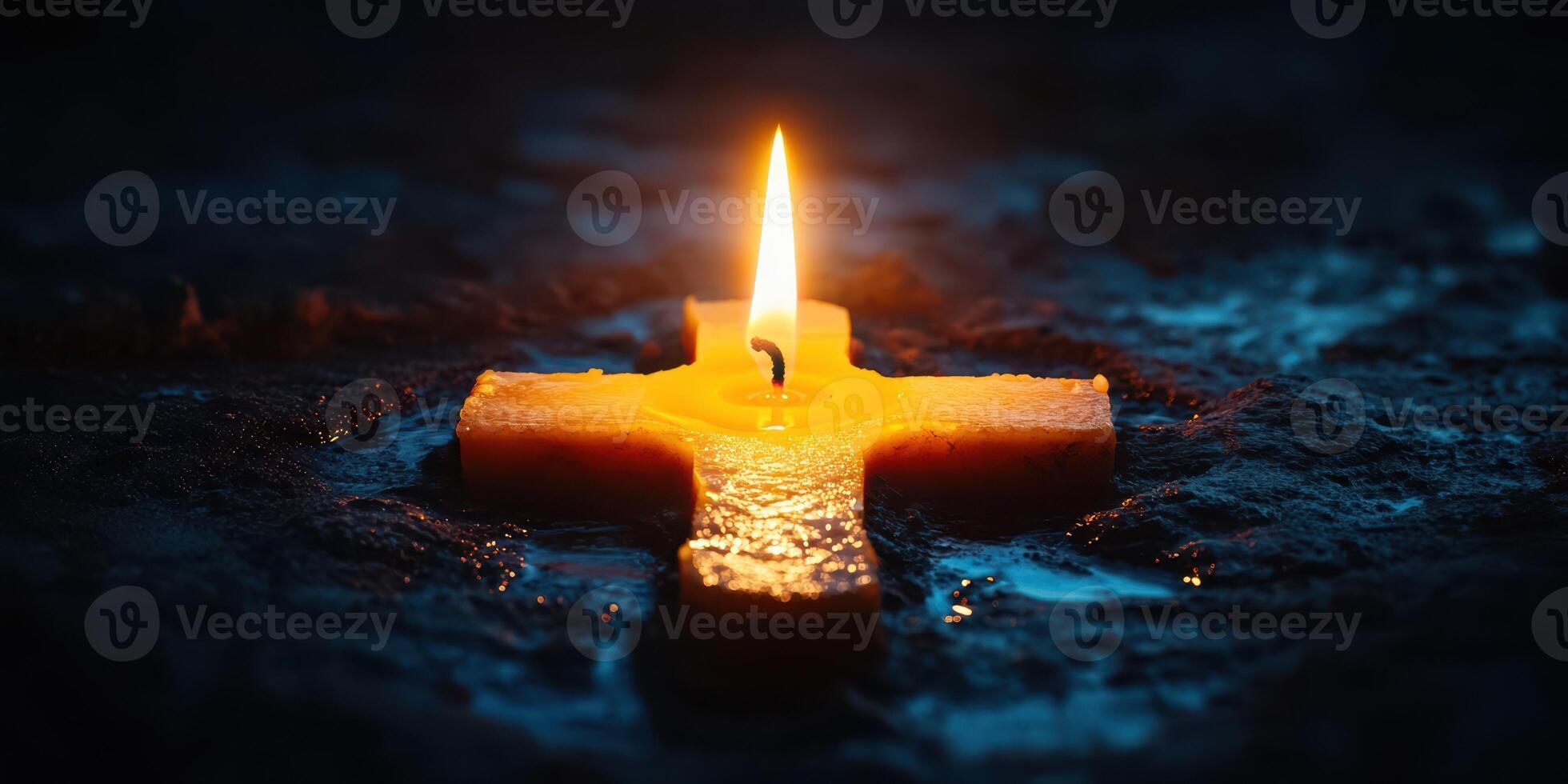 Candle illuminates a cross on a dark surface, symbolizing hope and faith in spiritual reflection photo