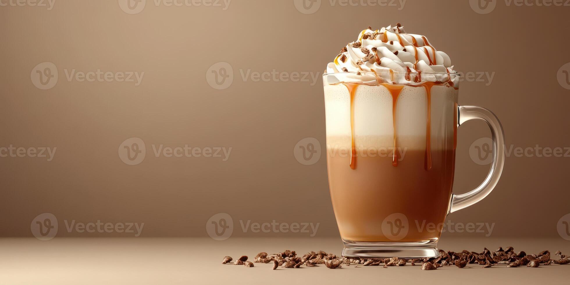 Creamy caramel latte topped with whipped cream and chocolate drizzle in a clear glass cup photo