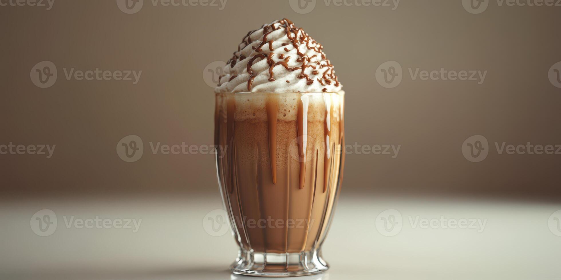 Creamy chocolate beverage topped with whipped cream and chocolate drizzle in a transparent glass photo