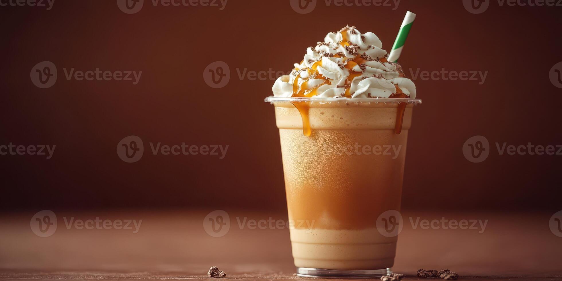 Delicious caramel whipped cream drink served in a clear cup with a green straw on a wooden table backdrop photo