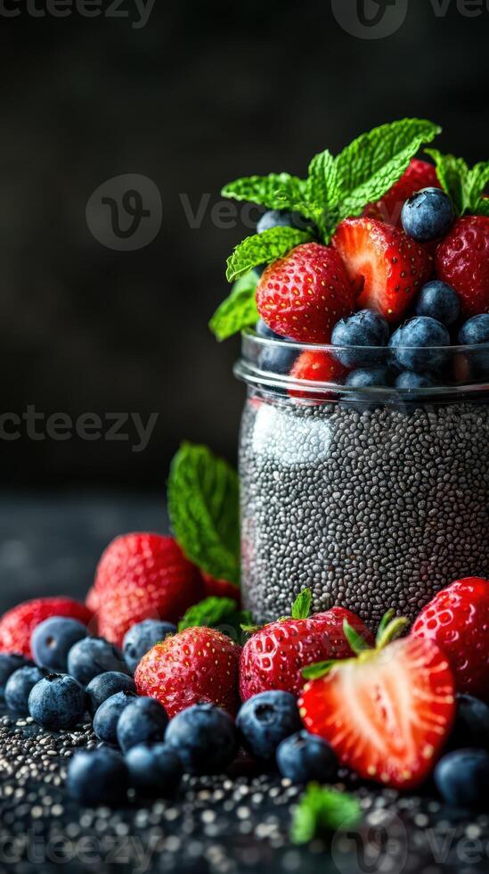Fresh berries and chia seeds arranged in a jar with mint leaves for a healthy dessert idea photo