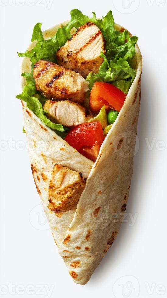 Grilled chicken wrap filled with fresh vegetables and greens in a soft tortilla photo