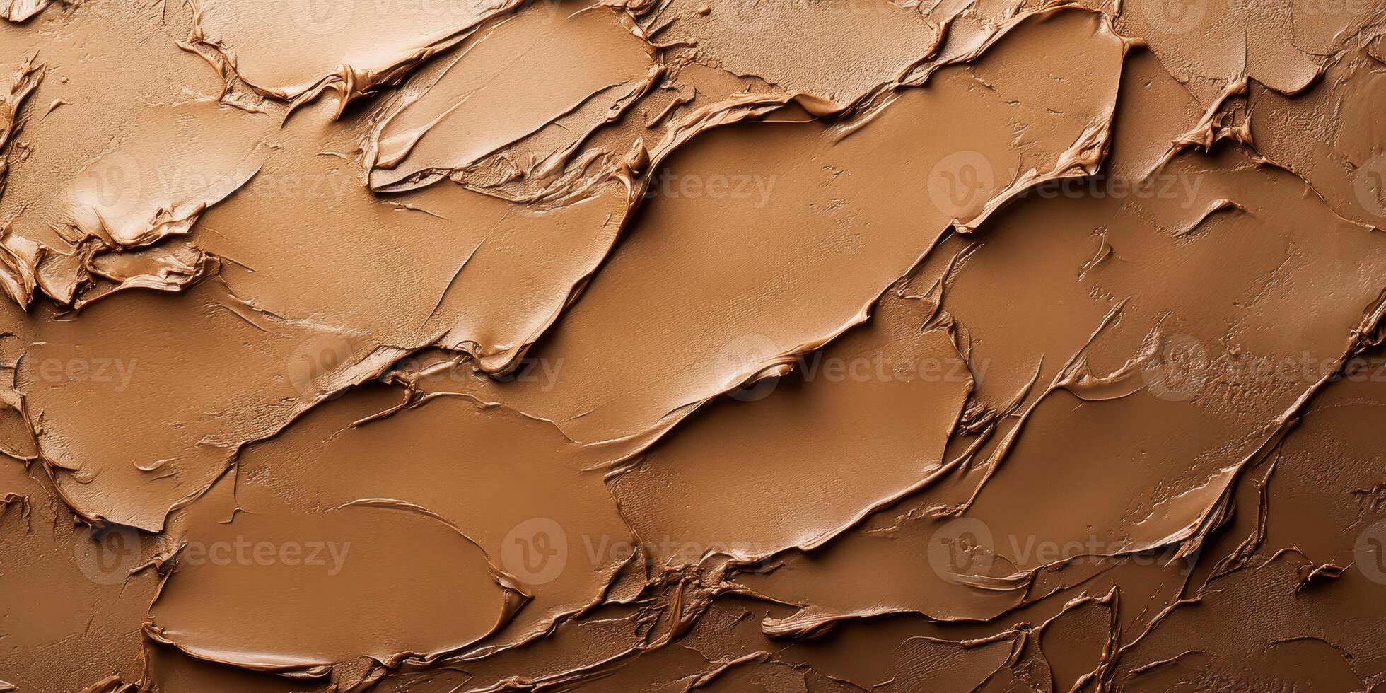 Smooth and textured brown plaster with organic patterns on a surface in natural lighting photo