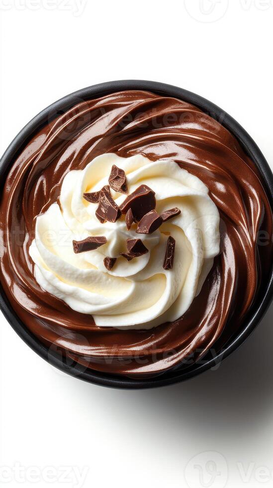 Decadent chocolate dessert topped with whipped cream and chocolate shavings in a black bowl photo