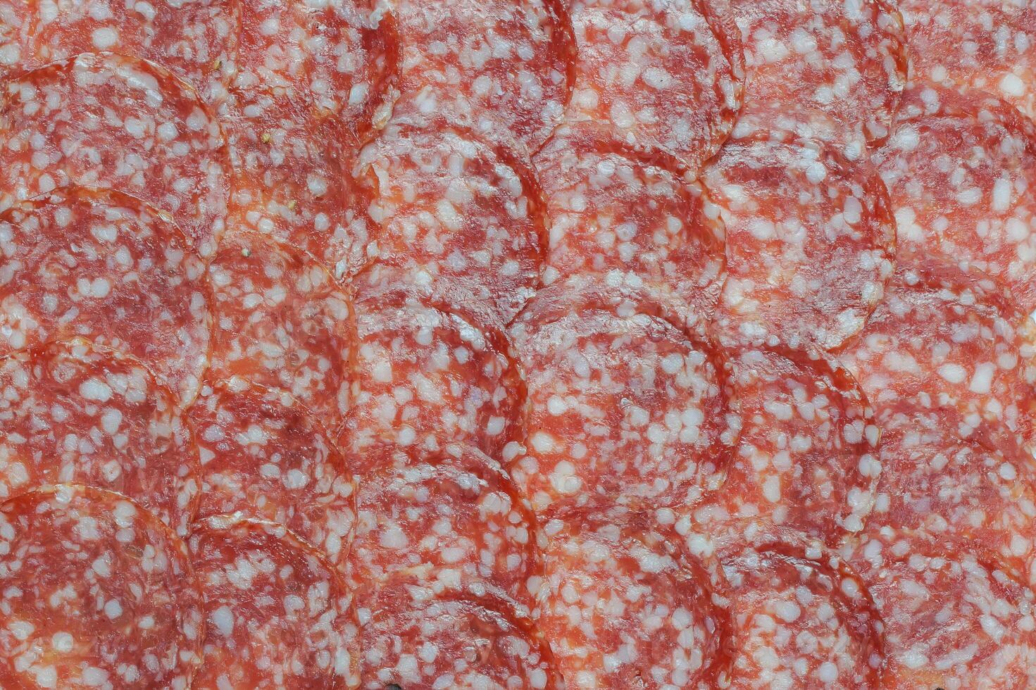 Sausage background texture pattern from sausage slices photo