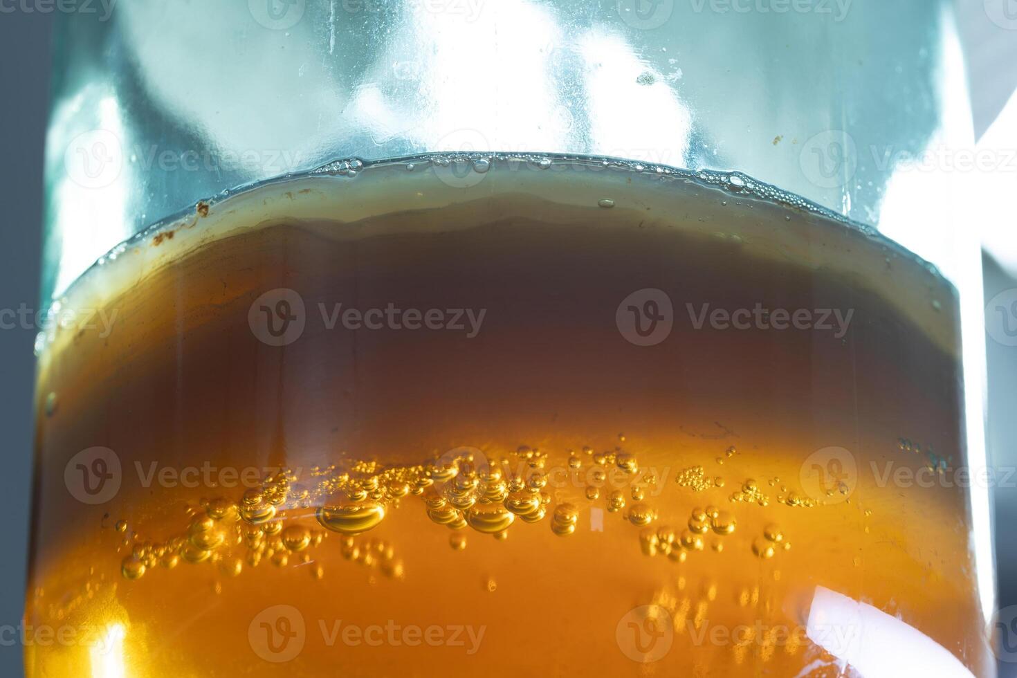 A Beautifully Sparkling Amber Beverage Delicately Poured into a Glass for Your Enjoyment photo