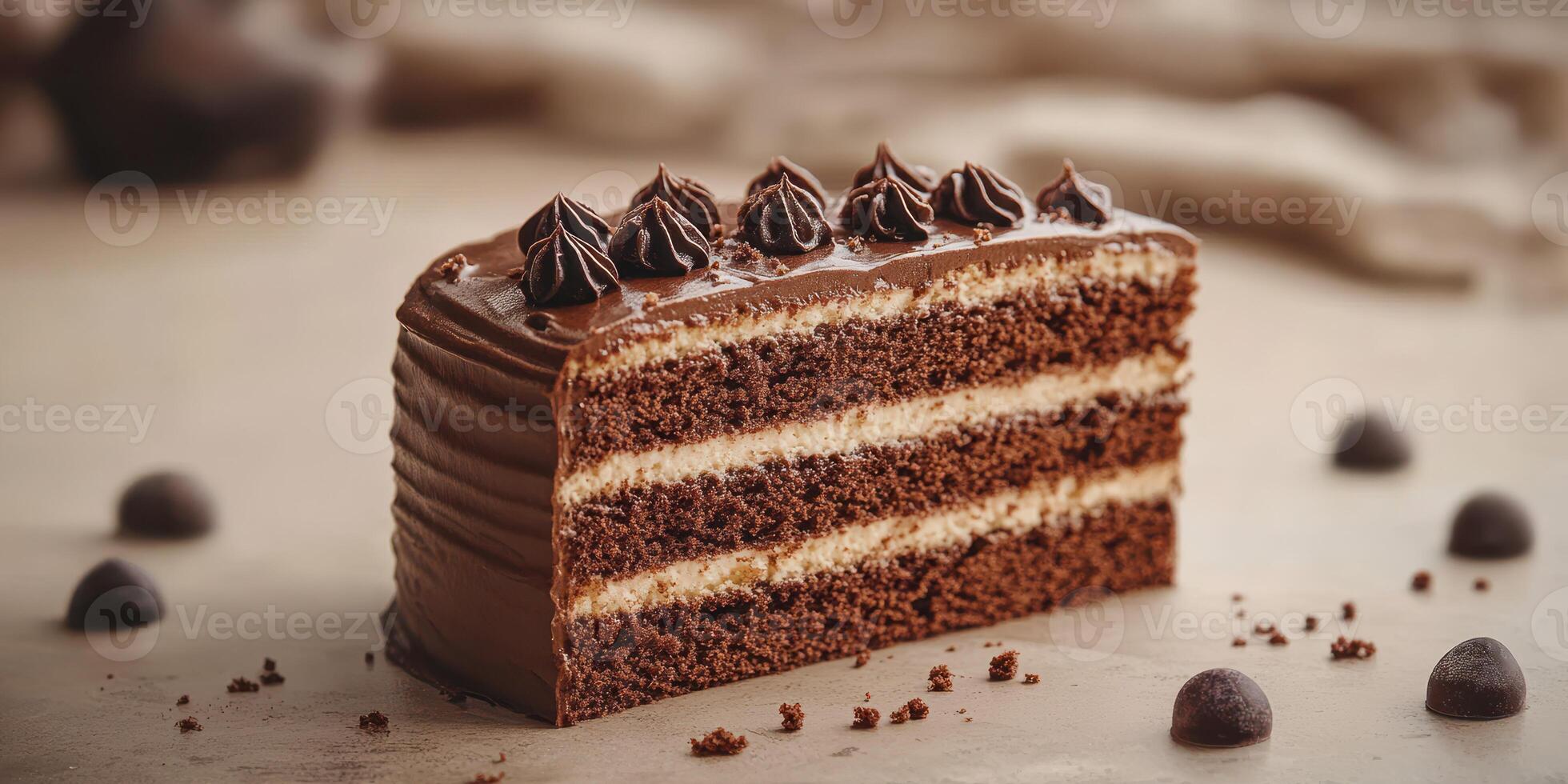 Rich chocolate layer cake displayed on wooden surface with chocolate truffles and baking tools in background photo