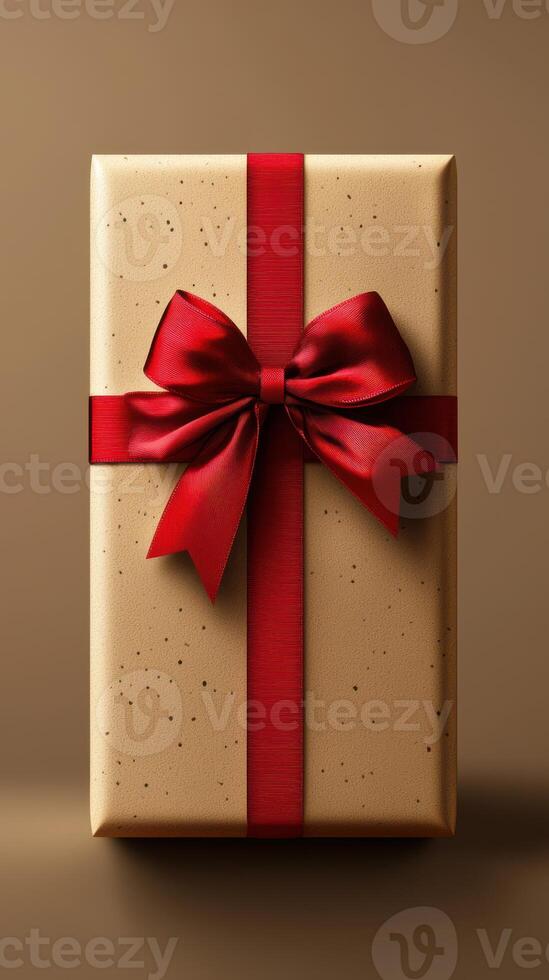 Elegant gift box with red ribbon and bow displayed on a neutral surface photo