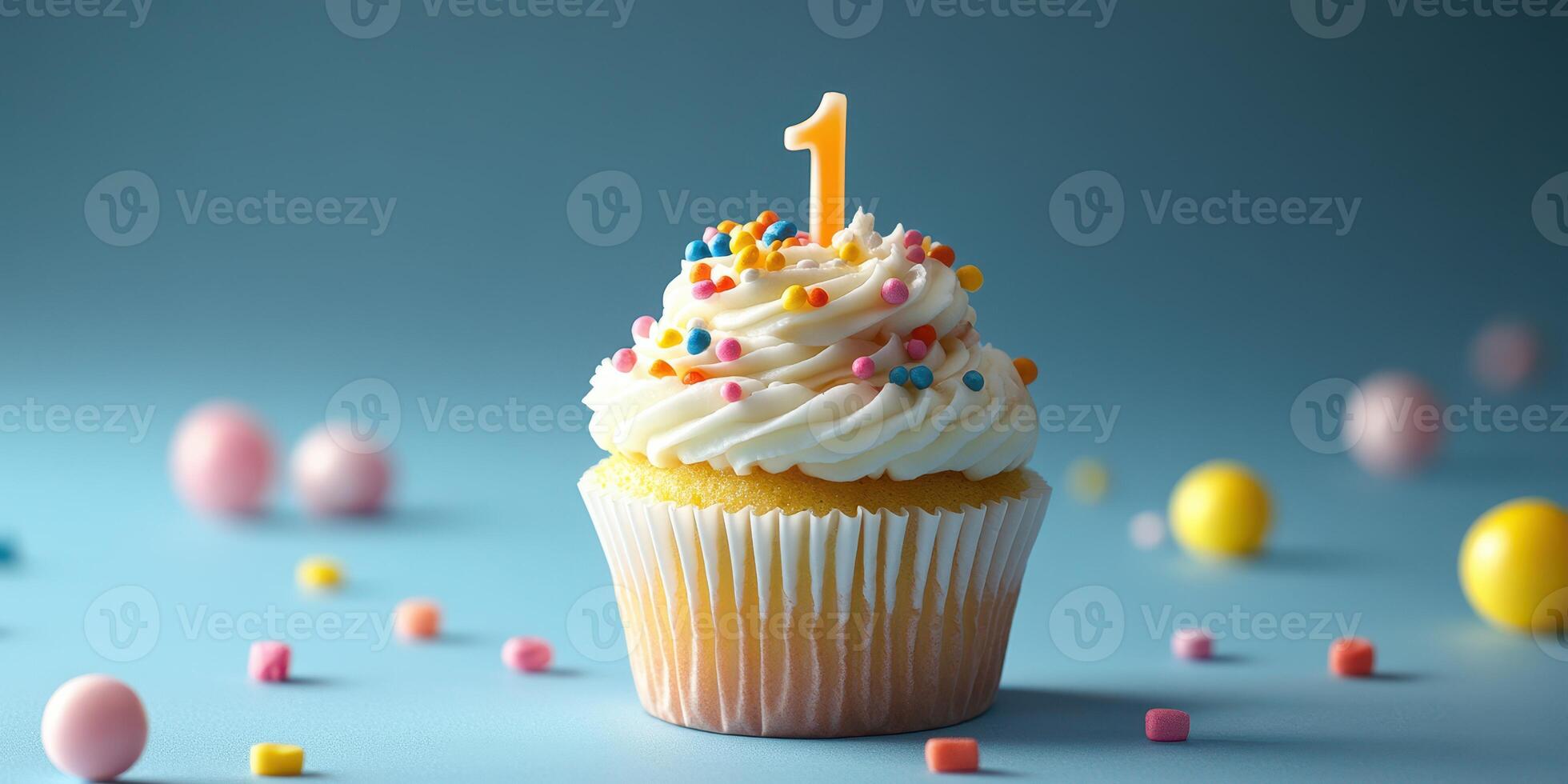 Colorful cupcake with a number one candle surrounded by candies on a blue background celebrating a first birthday photo