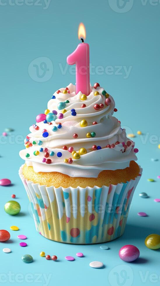 Colorful first birthday cupcake with a candle and sprinkles on a blue background photo