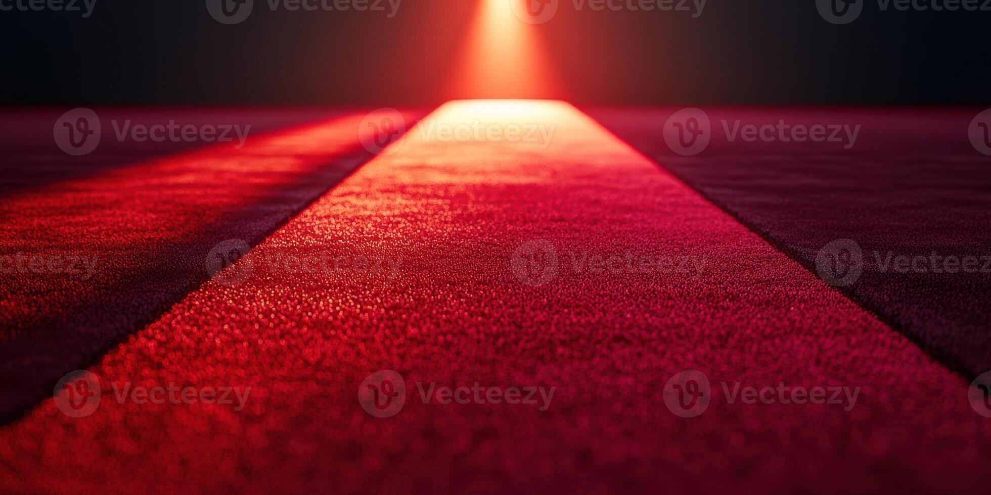 Bright red carpet leading to a spotlight in a dark setting, creating a dramatic atmosphere for an event photo