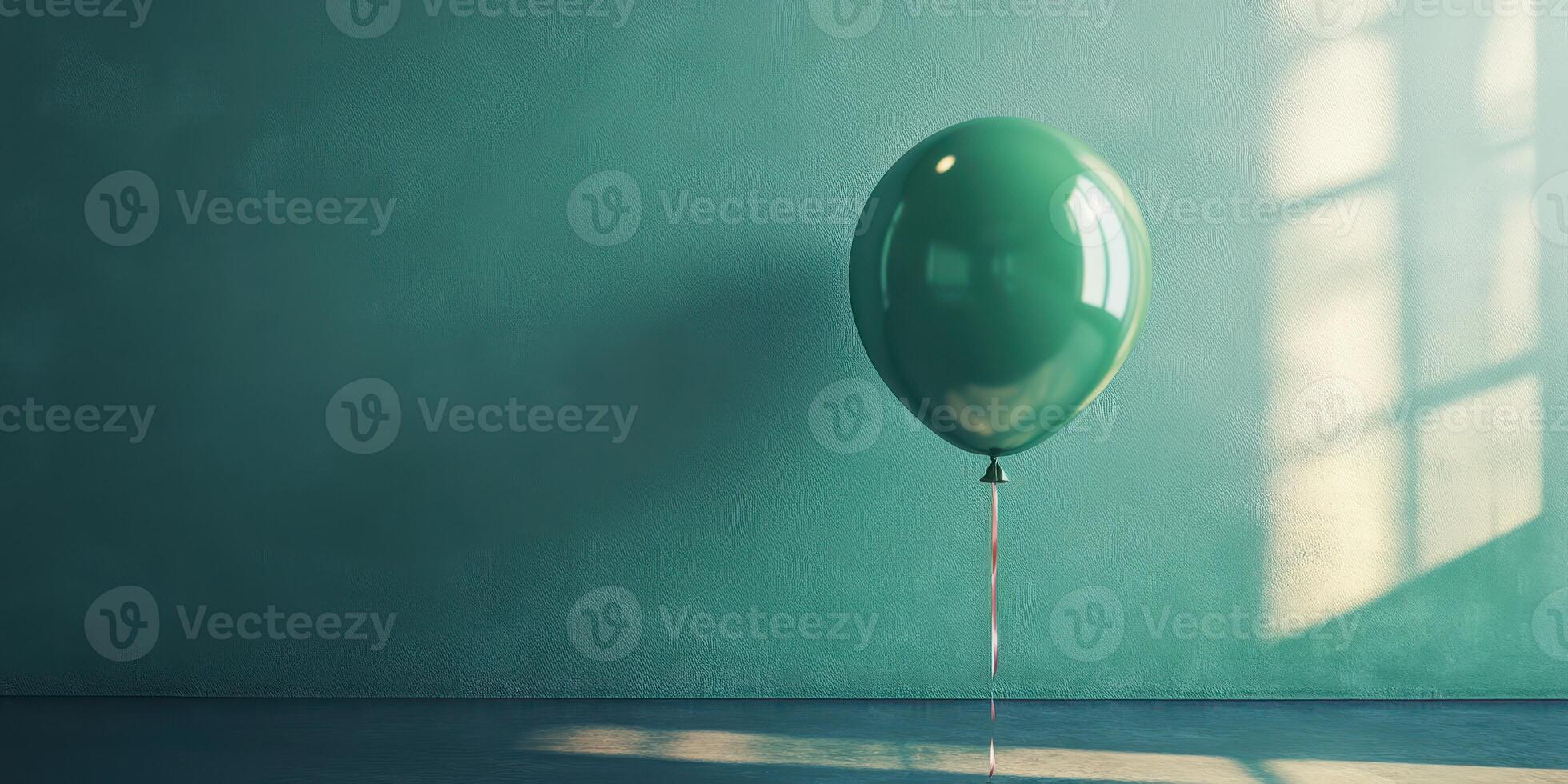 Green balloon floats against a teal wall in soft afternoon light creating a tranquil atmosphere photo