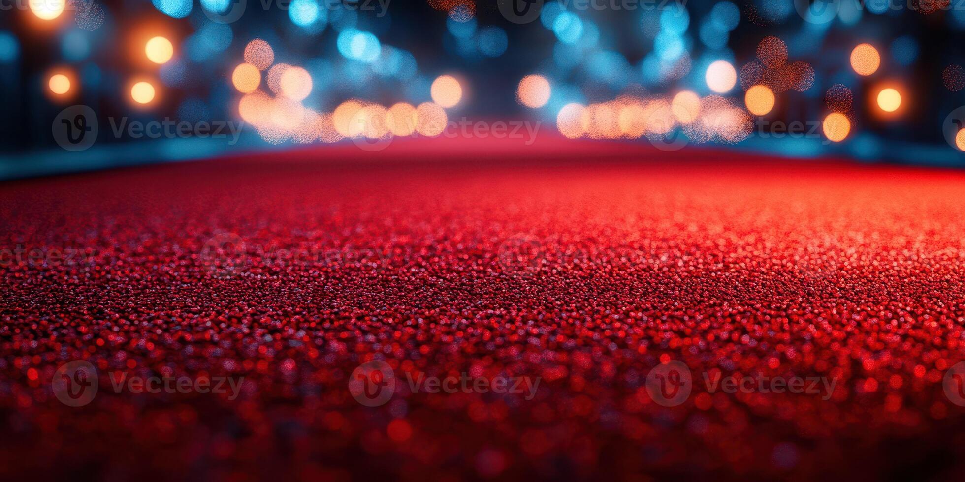 Red carpet laid out for a glamorous event with soft lights shining in the background during evening hours photo
