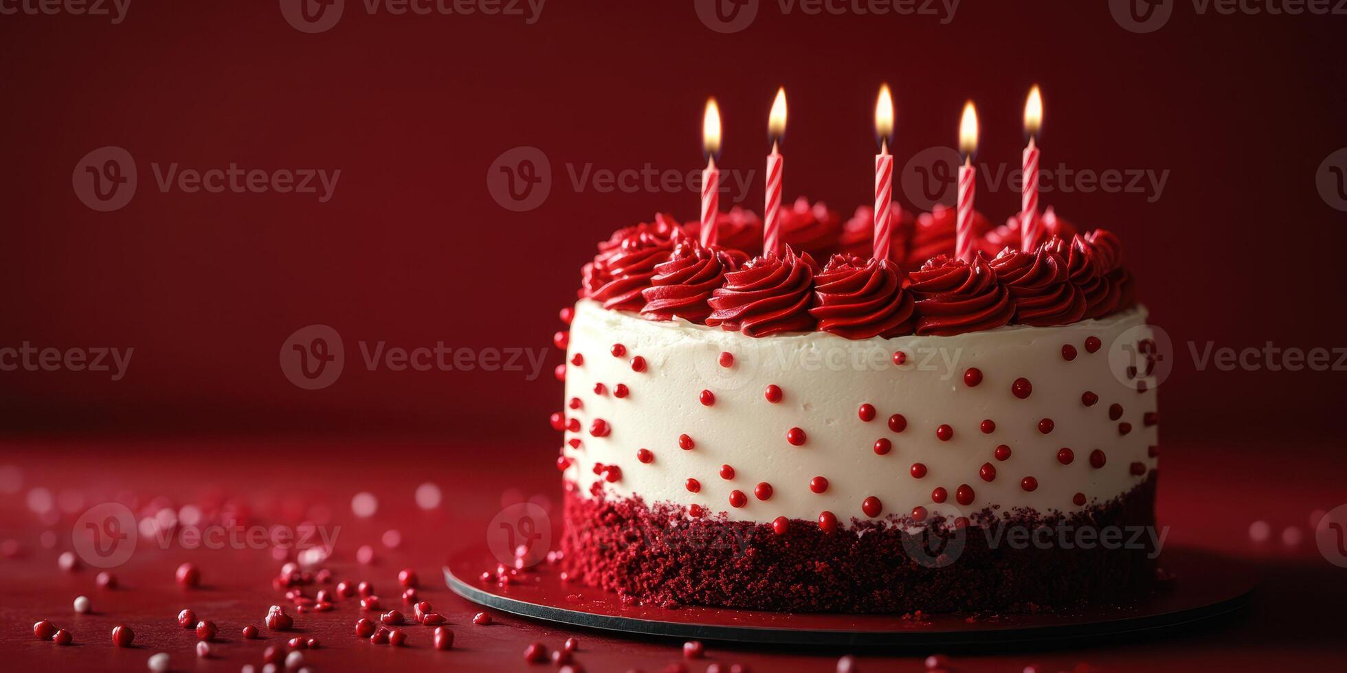 Delicious red velvet cake with candles ready for celebration on a festive table photo