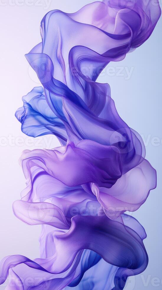 Soft flowing fabric in shades of purple creating an artistic display against a light background photo