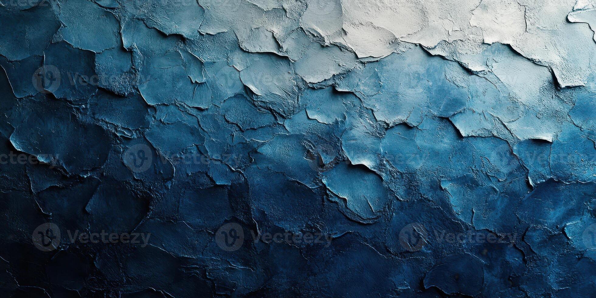 Textured blue wall with layers of paint and plaster showcasing a gradient effect from light to dark photo