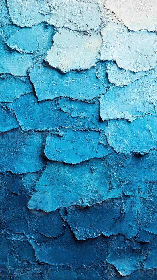 Beautiful layered texture of blue paint on surface captures a striking gradient from light to dark tones photo