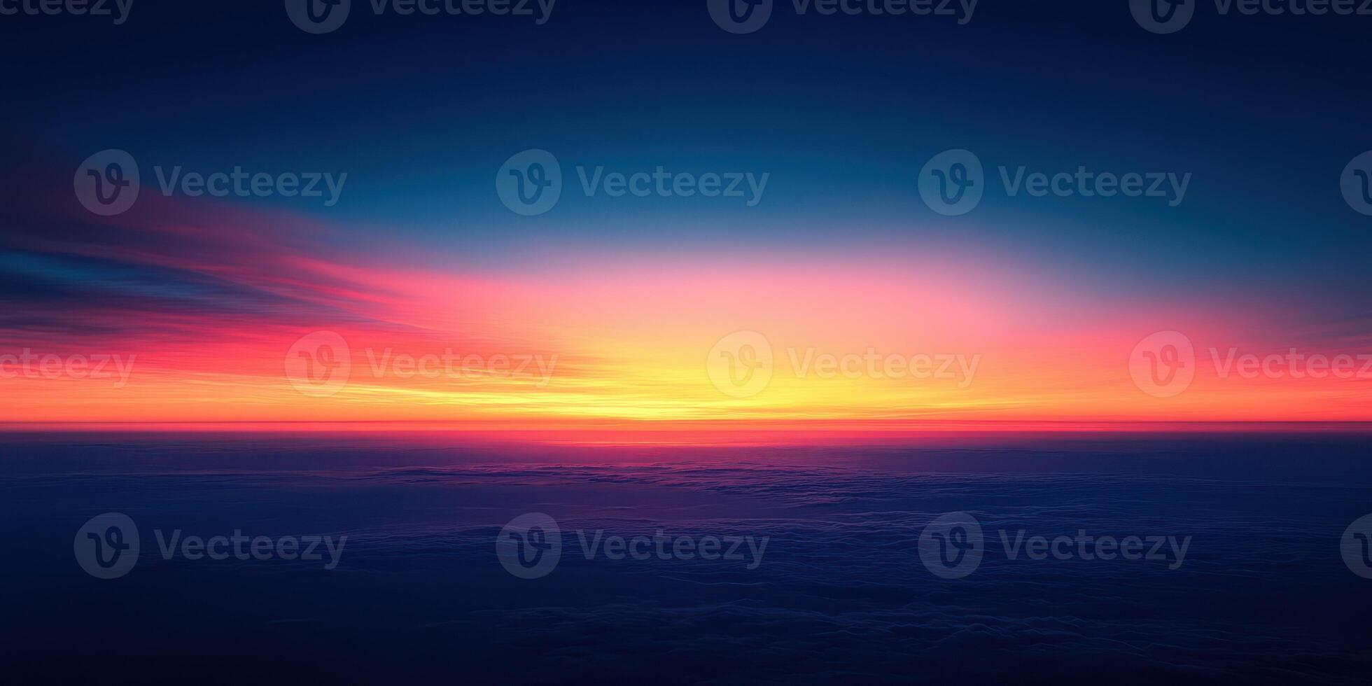 Vibrant sunset hues illuminate the horizon over the calm ocean during twilight hours photo