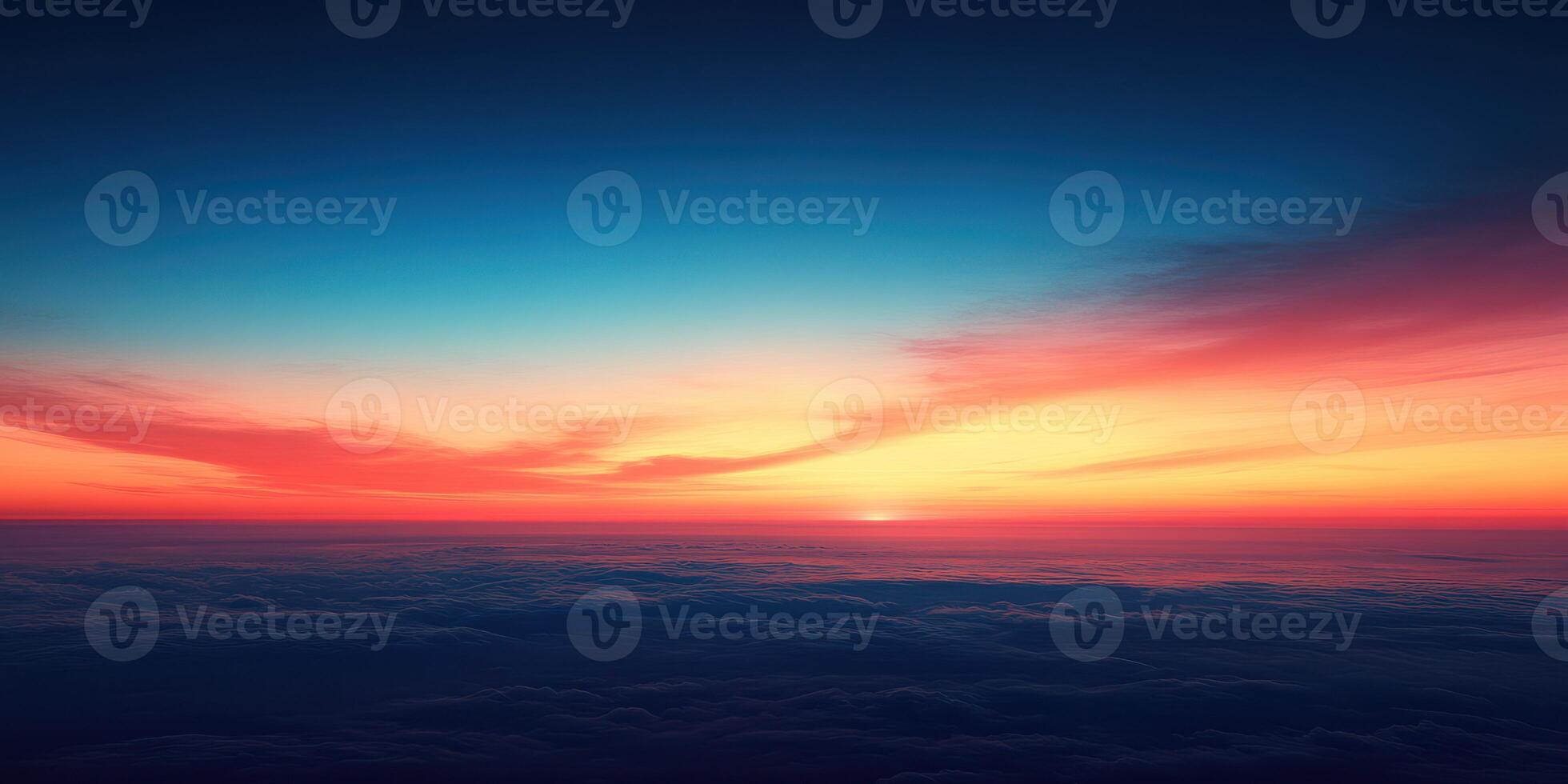 Colorful sunset over clouds viewed from a high altitude showcasing vibrant hues of orange, pink, and blue photo
