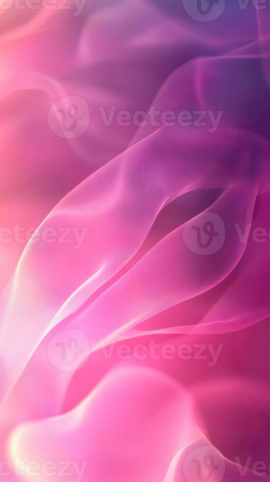 Colorful flowing fabric creates a soft abstract background with pink and purple hues photo