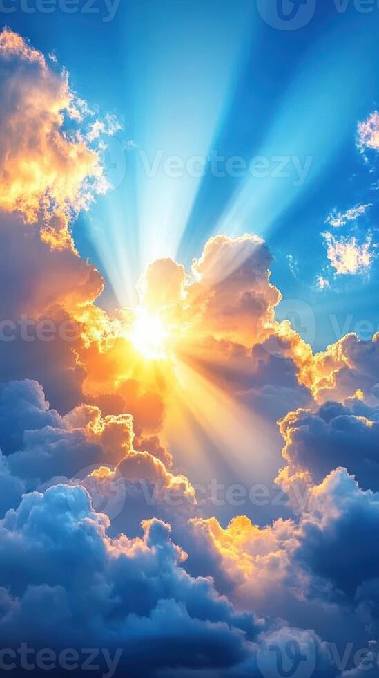 Bright sun rays shining through fluffy clouds at sunset creating a beautiful colorful sky photo
