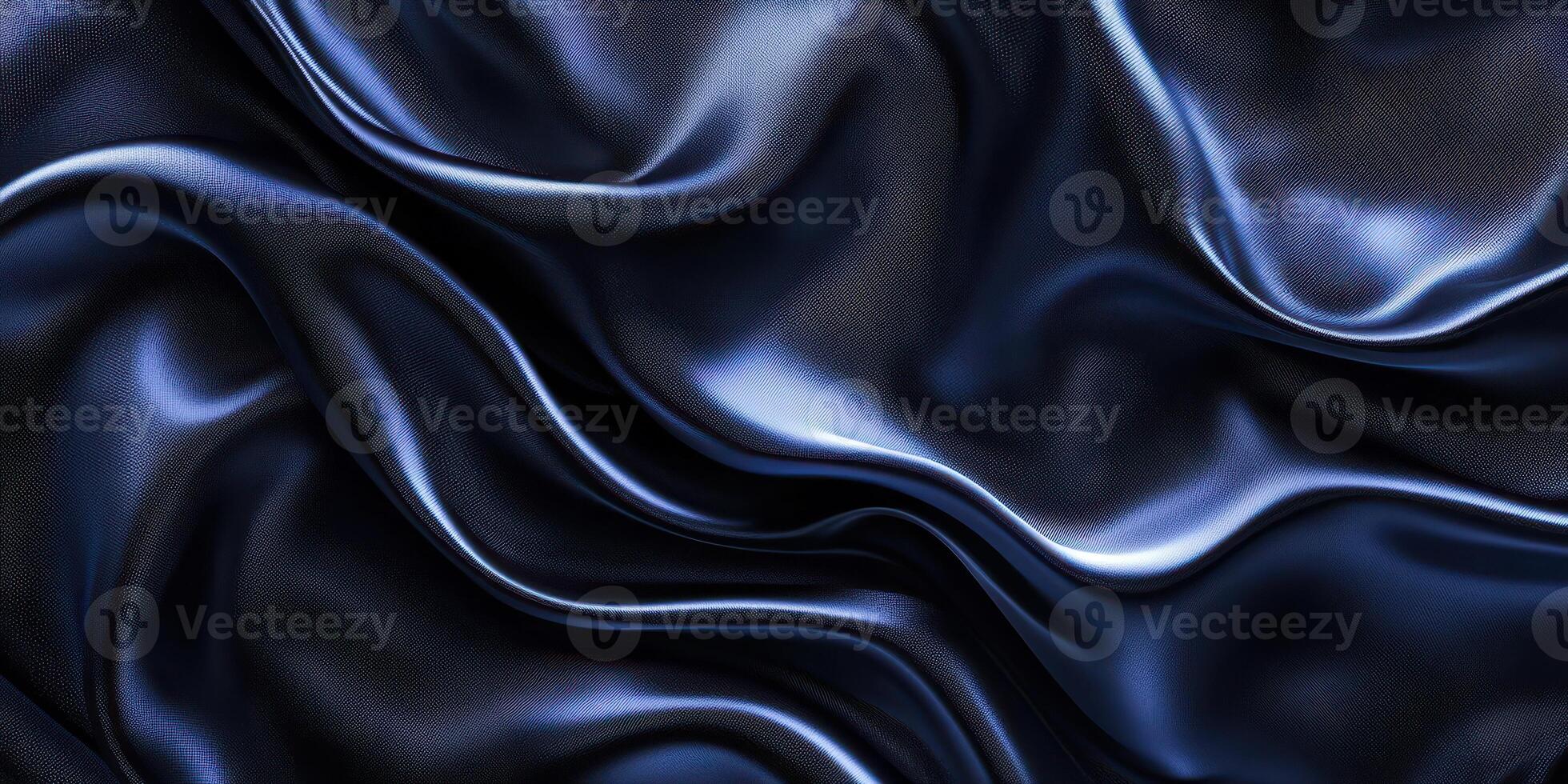 Elegant dark blue silk fabric drapes softly under soft lighting creating smooth textures and luxurious appeal photo