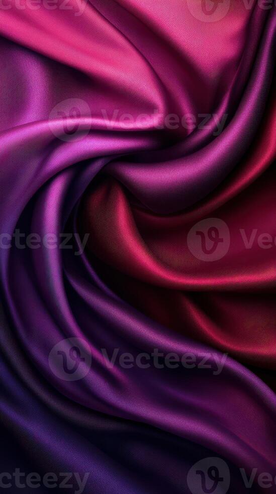 Colorful silk fabric draping in deep shades of purple and red with smooth texture and elegant flow photo