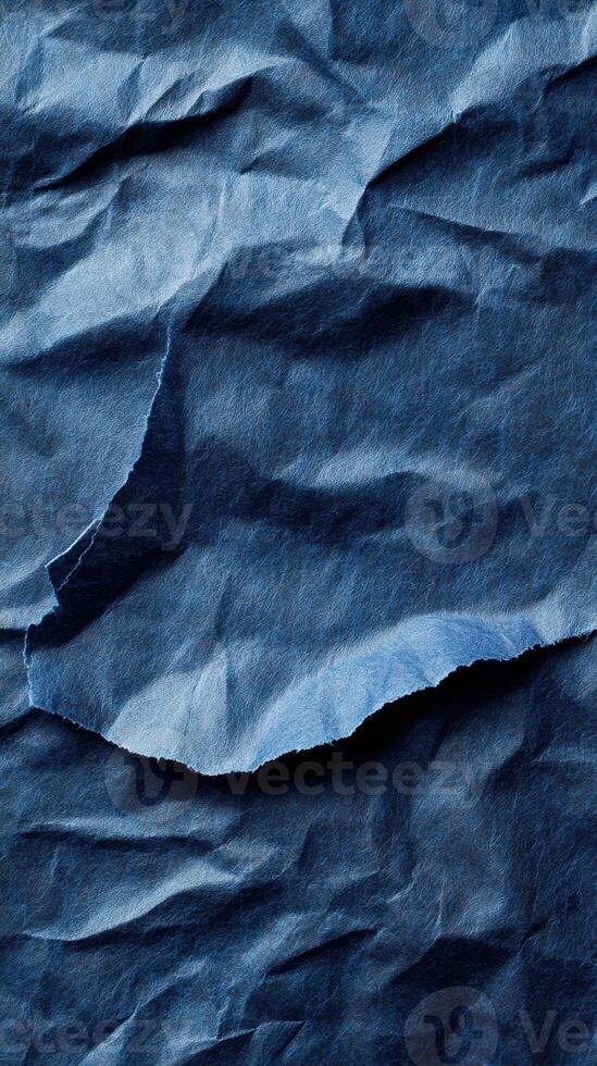 Crumpled blue paper texture showcasing intricate folds and shadows for artistic design photo