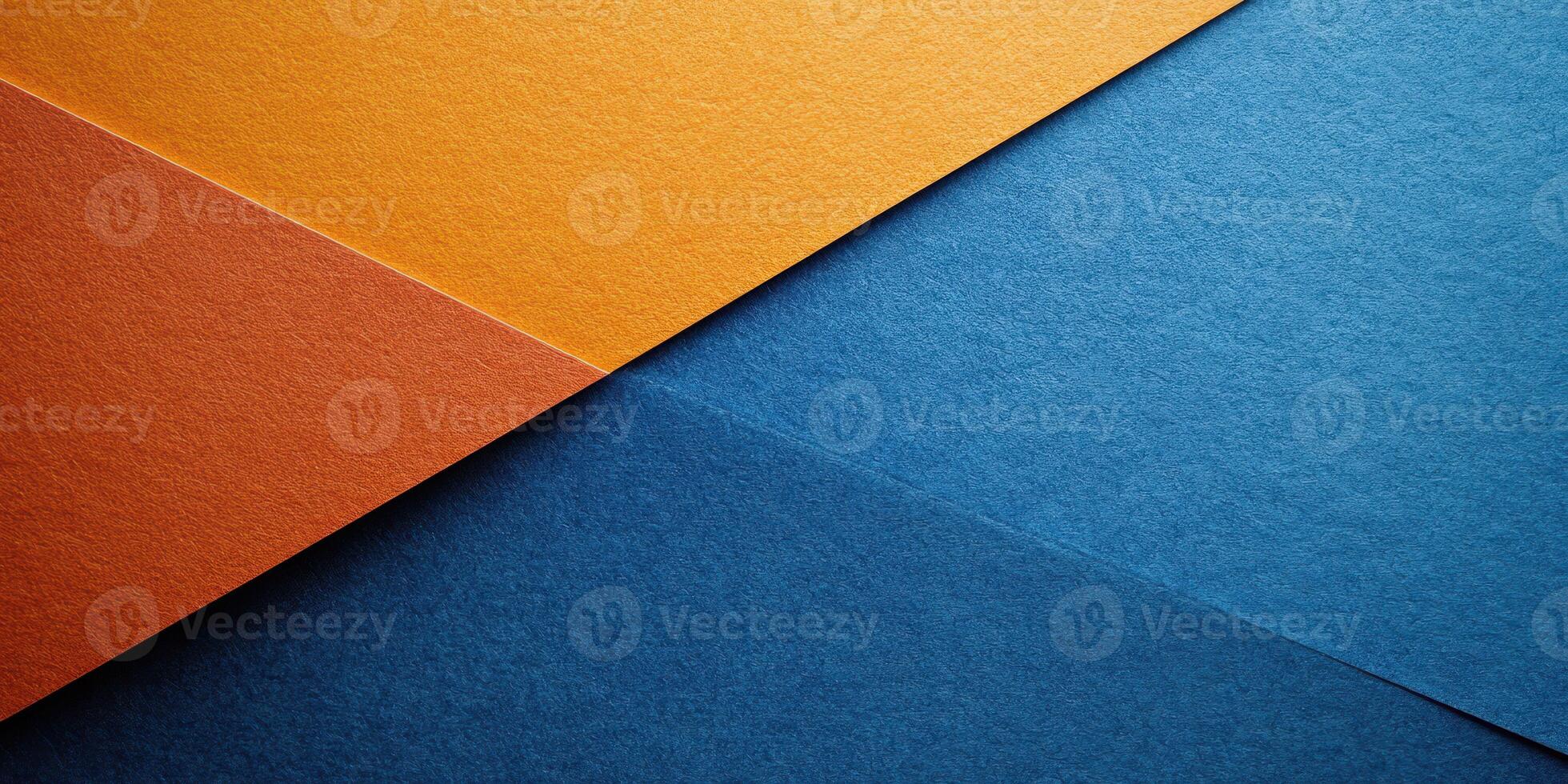 Colorful textured paper sheets arranged at an angle showcasing vibrant blue and orange hues in a creative workspace photo
