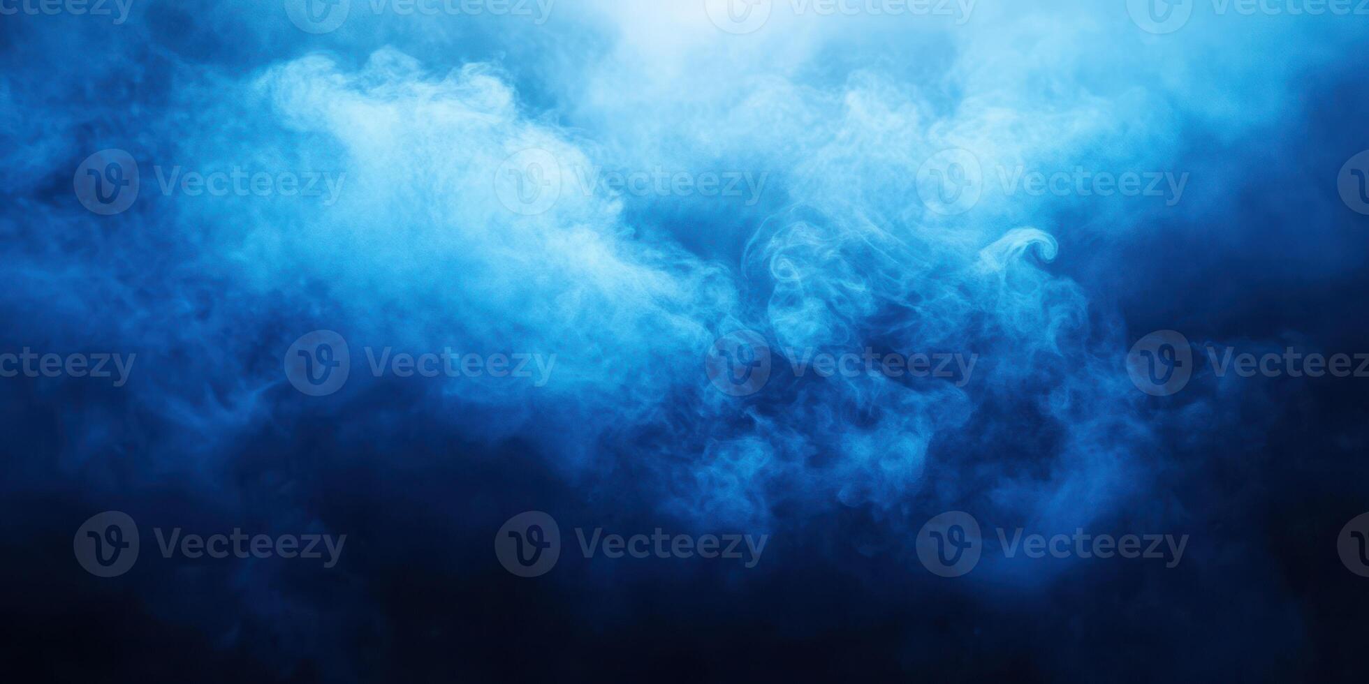 Soft blue smoke swirls in a dark atmosphere creating a mysterious ambiance for creative backgrounds and effects photo