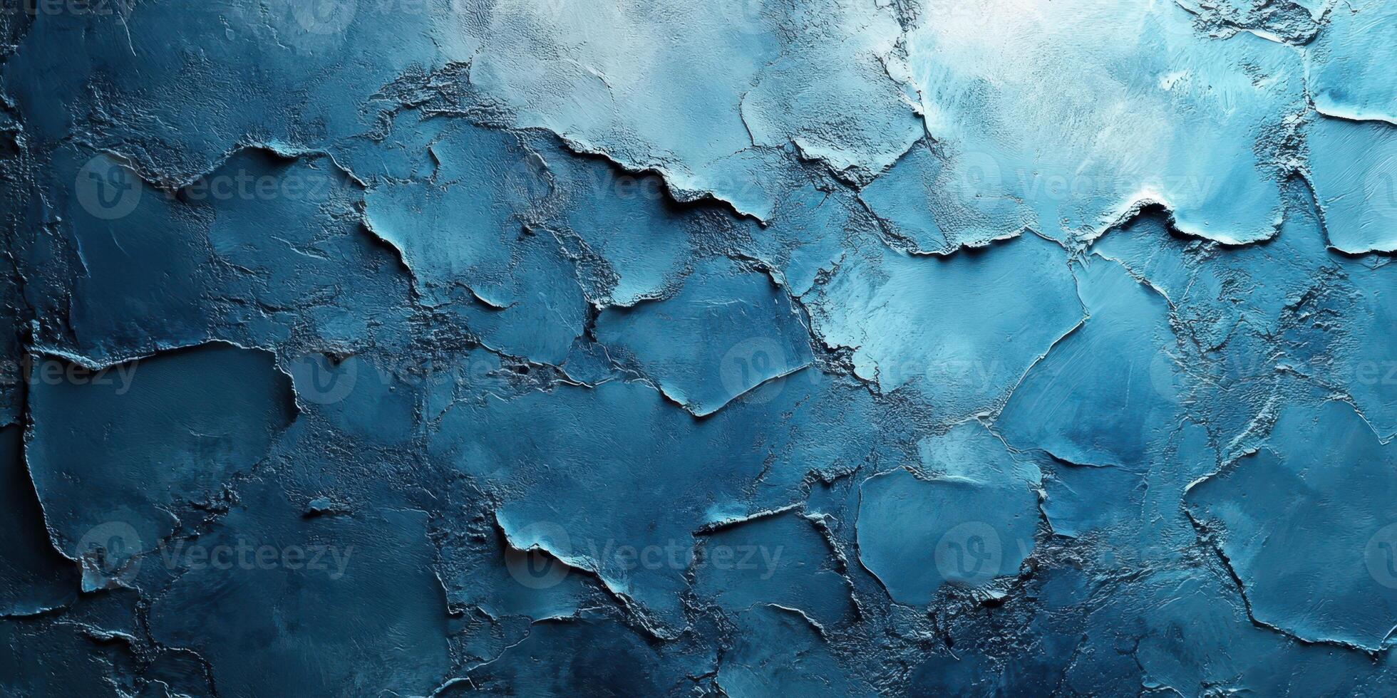 Textured blue wall with cracks displaying variation in shades and tones photo
