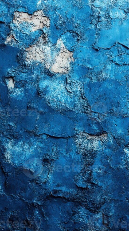 Textured blue wall showing cracks and imperfections in a rustic urban setting photo