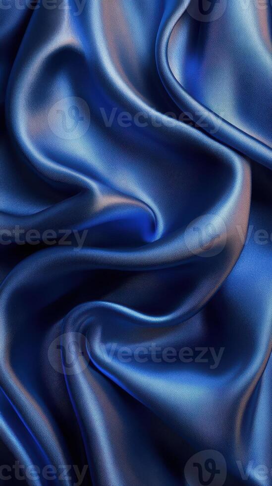 Luxurious deep blue satin fabric drapes elegantly to showcase its smooth texture and alluring sheen in soft lighting photo