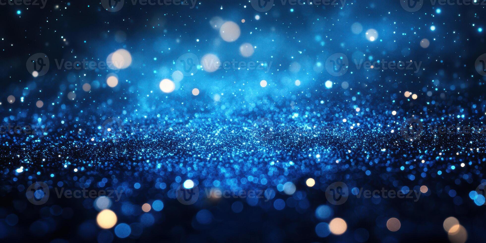 Glittering blue particles create a mesmerizing effect in a dark backdrop during the evening photo