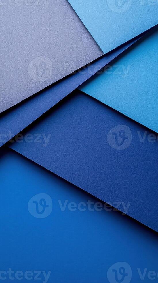 Layers of blue paper with varying shades creating a textured background in an artistic arrangement photo
