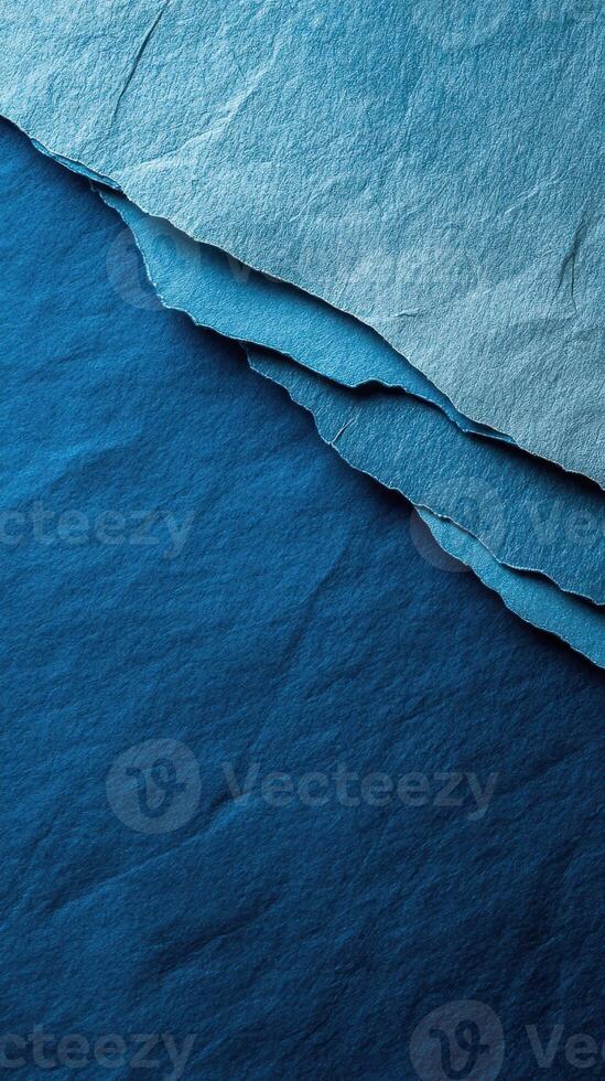 Shades of blue paper layered artfully to create a textured visual display photo