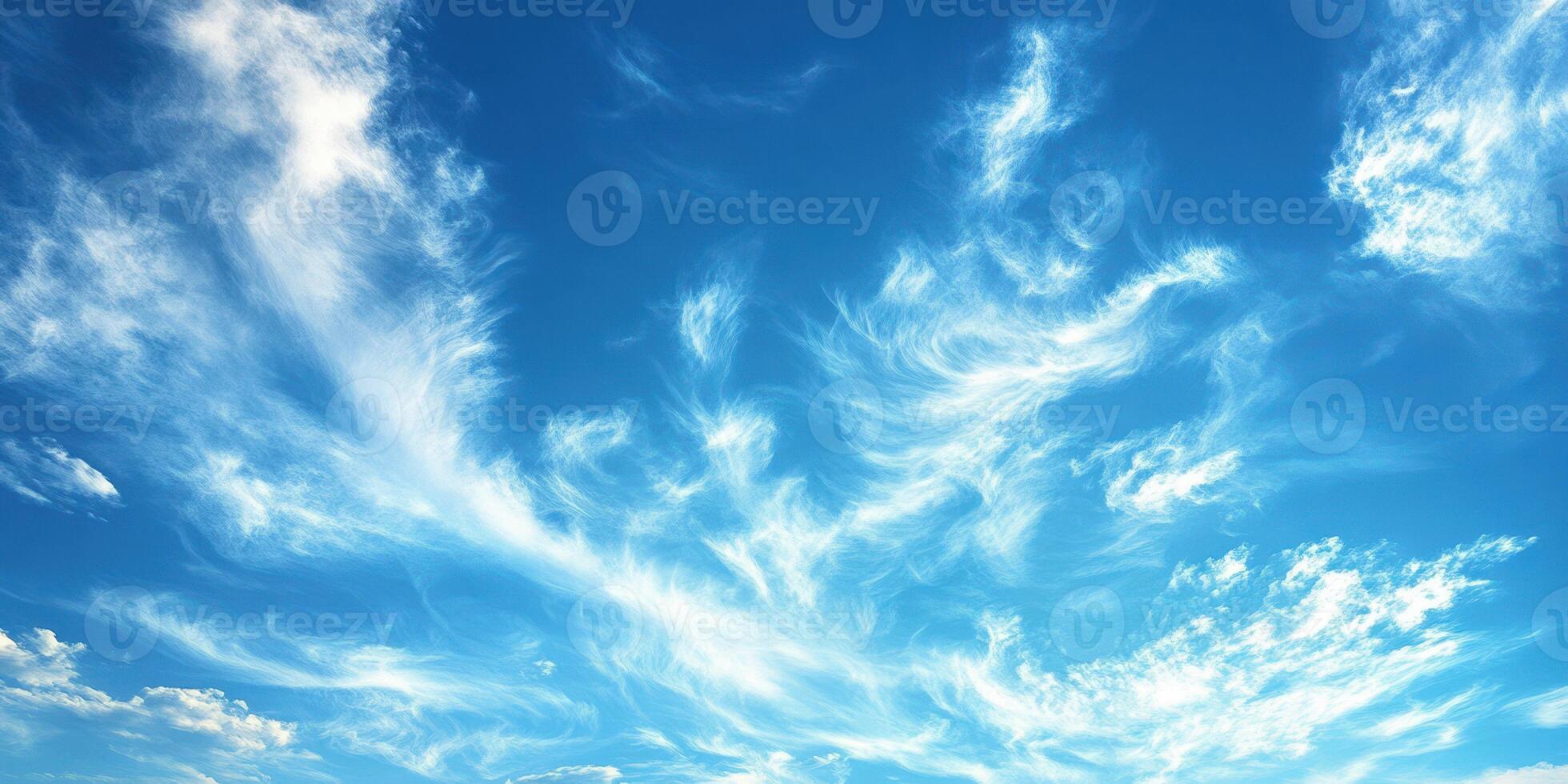 Beautiful wispy clouds display artistry against a bright blue sky during a sunny afternoon photo
