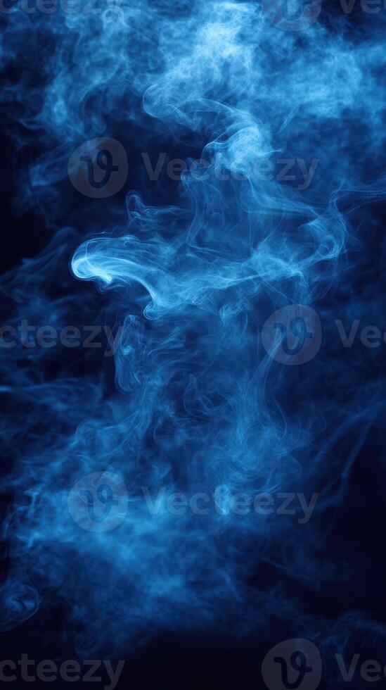 Ethereal blue smoke swirls creating an enchanting atmosphere in a dark setting photo