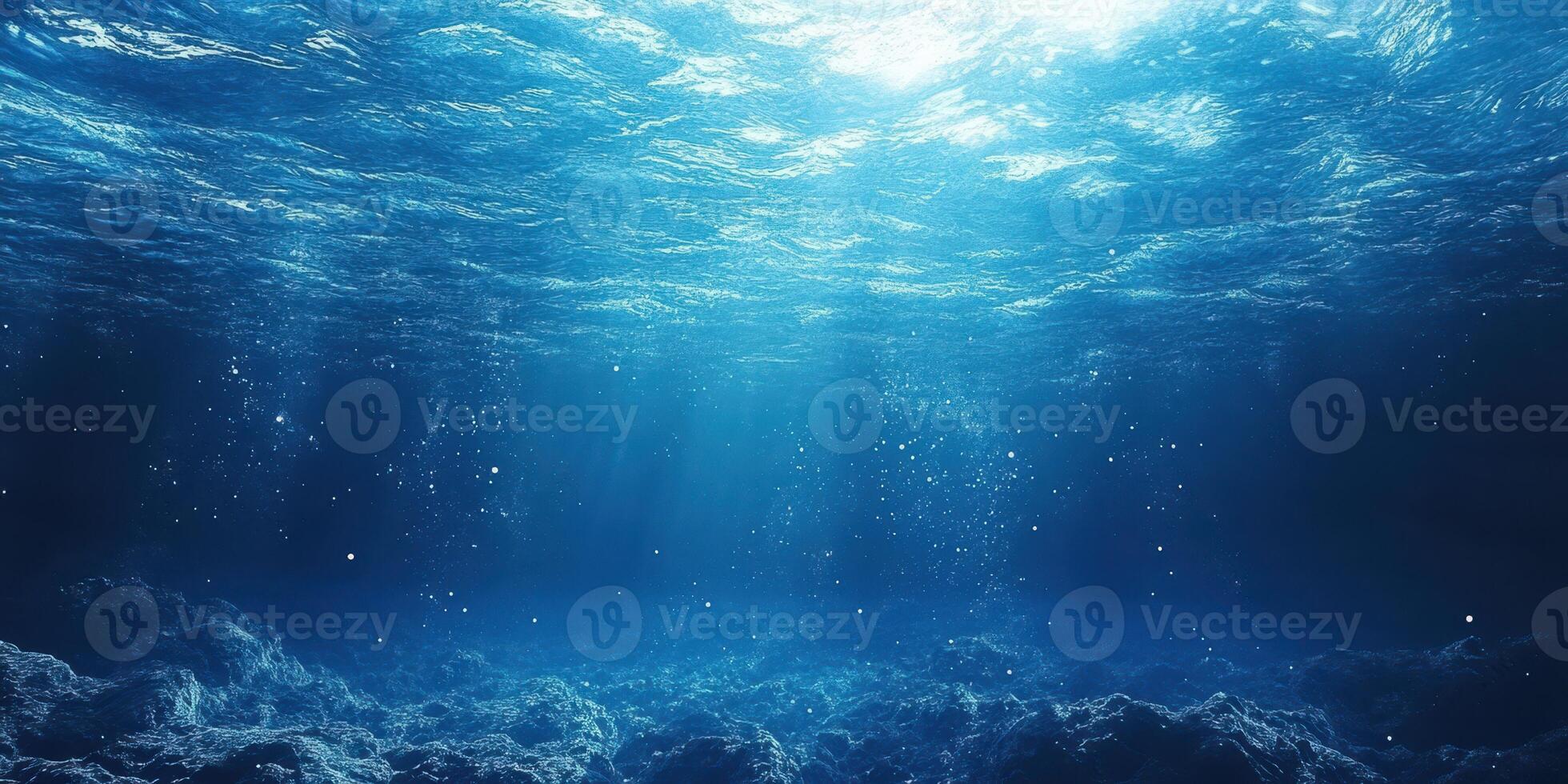 Sunlight filtering through the ocean surface creates a serene underwater atmosphere with soft blue tones photo