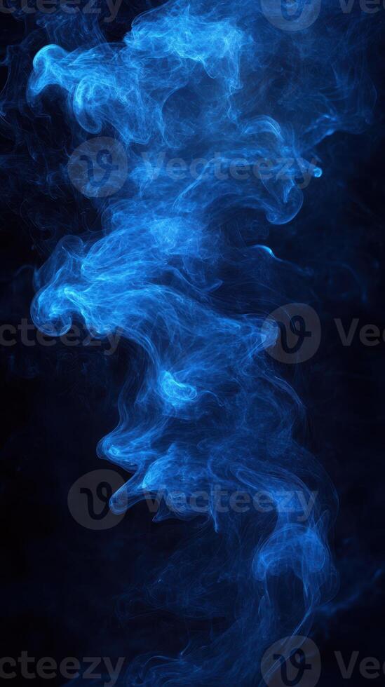 Swirling blue smoke against a dark background creates a mysterious and captivating atmosphere photo