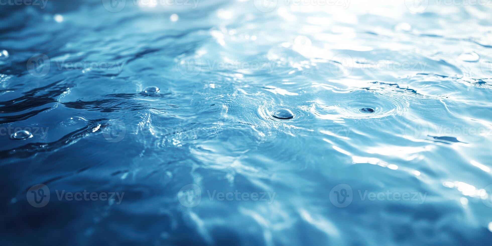 Rippling water surface with droplets reflecting sunlight in a serene environment photo
