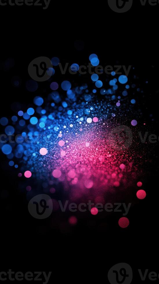 Vibrant blue and pink particle burst creating a mesmerizing visual effect at night photo