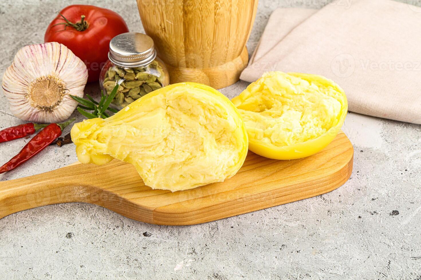 A wooden cutting board with a knife and a pepper photo