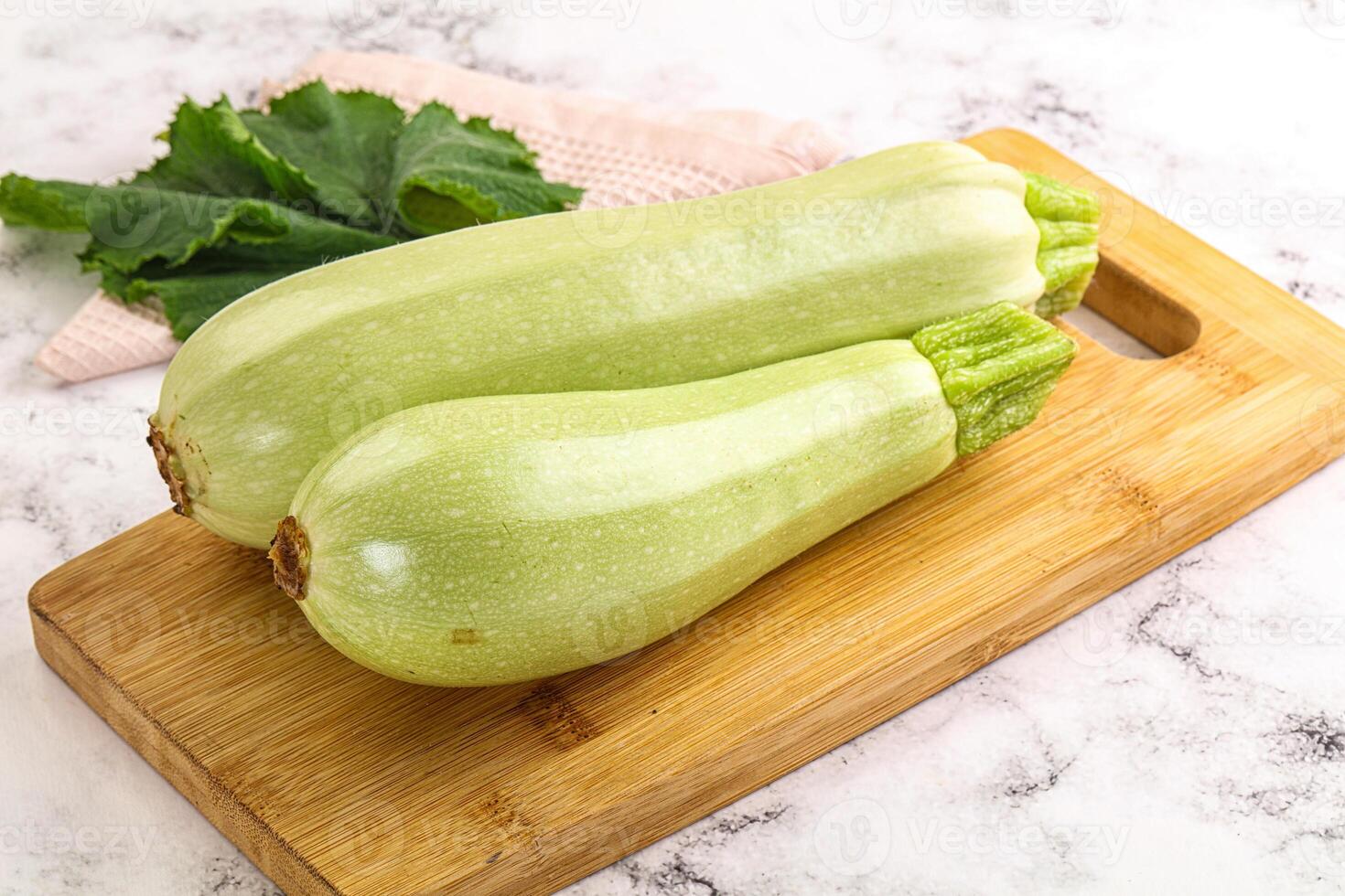 Two green zucchini on a cutting board photo