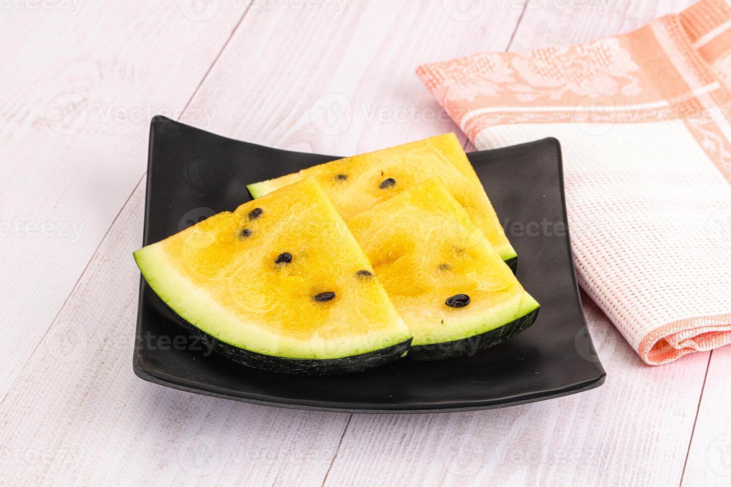 A black plate with two slices of watermelon photo