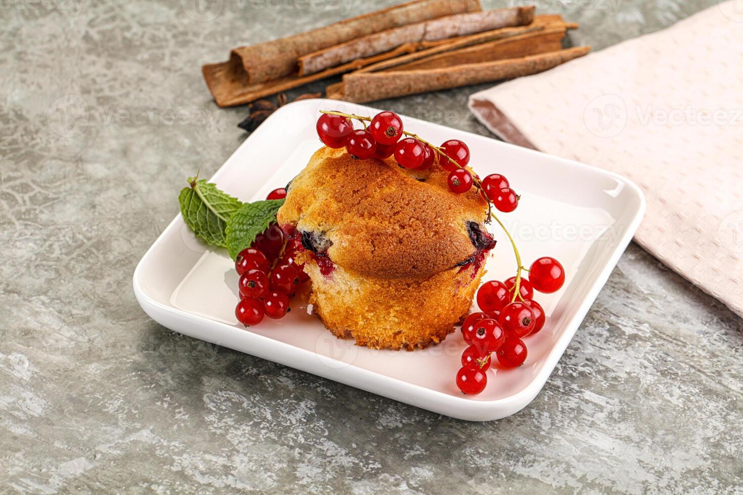 A pastry on a plate with berries and cinnamon photo