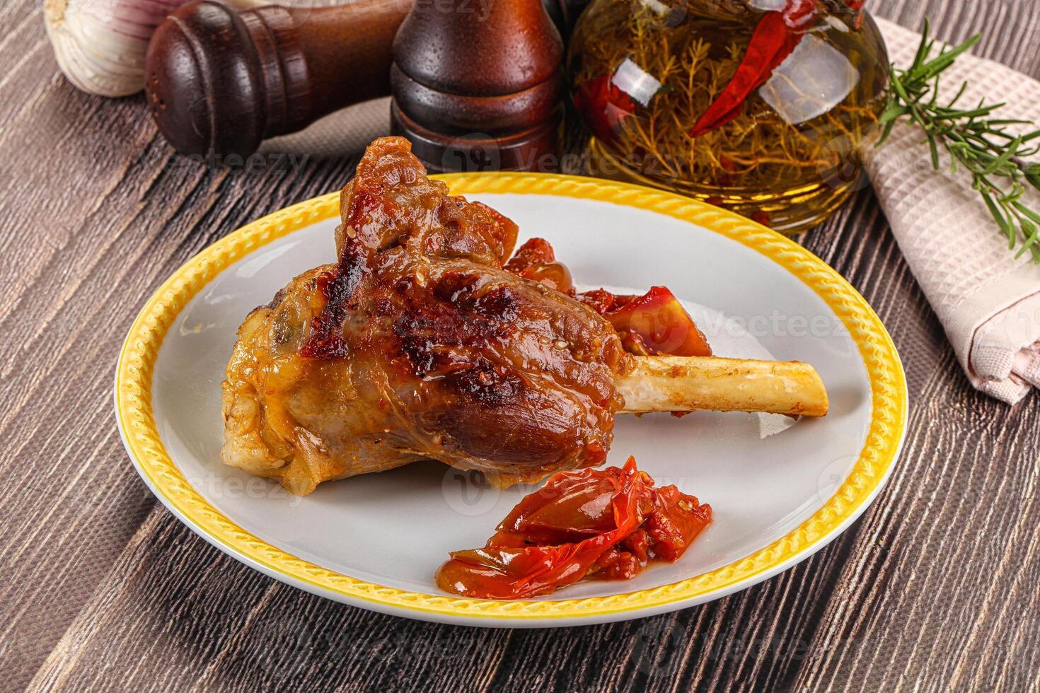 A plate of food with a knife and a bottle of wine photo